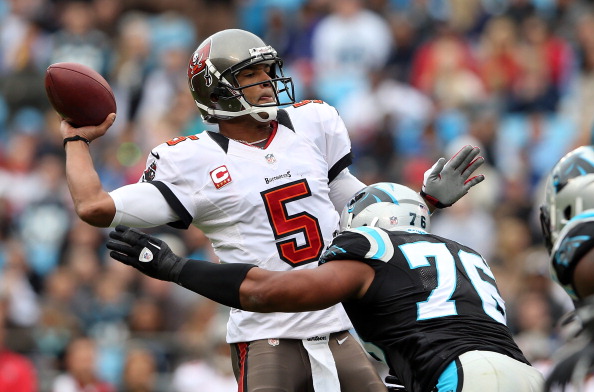 CHARLOTTE, NC - NOVEMBER 18:   Greg Hardy #76 of the Carolina Panthers hits Josh Freeman #5 of the Tampa Bay Buccaneers as he throws a pass during their game at Bank of America Stadium on November 18, 2012 in Charlotte, North Carolina.  (Photo by Streeter Lecka/Getty Images)
