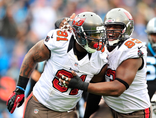 CHARLOTTE, NC - NOVEMBER 18:  Da'Quan Bowers #91 and Gerald McCoy #93 of the Tampa Bay Buccaneers celebrate after Bowers' sack of quarterback Cam Newton #1 of the Carolina Panthers during play at Bank of America Stadium on November 18, 2012 in Charlotte, North Carolina.  (Photo by Grant Halverson/Getty Images)