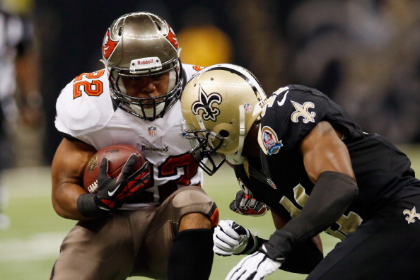 NEW ORLEANS, LA - DECEMBER 16: Eric Wright #21 of the Tampa Bay Buccaneers is tackled by Roman Harper #41 of the New Orleans Saints at the Mercedes-Benz Superdome on December 16, 2012 in New Orleans, Louisiana. (Photo by Chris Graythen/Getty Images)