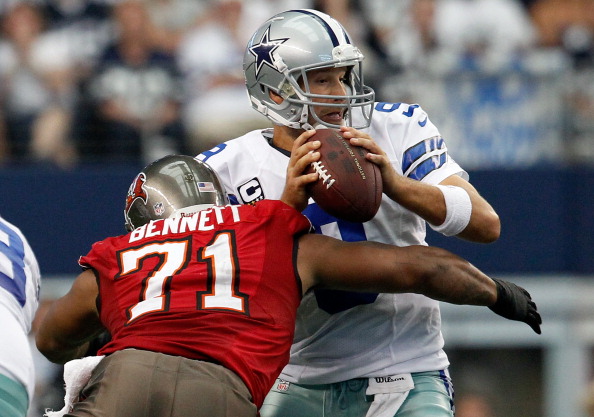 ARLINGTON, TX - SEPTEMBER 23: Tony Romo #9 of the Dallas Cowboys fumbles the ball after being hit by Michael Bennett #71 of the Tampa Bay Buccaneers at Cowboys Stadium on September 23, 2012 in Arlington, Texas. The Dallas Cowboys beat the Tampa Bay Buccaneers 16-10. (Photo by Tom Pennington/Getty Images)