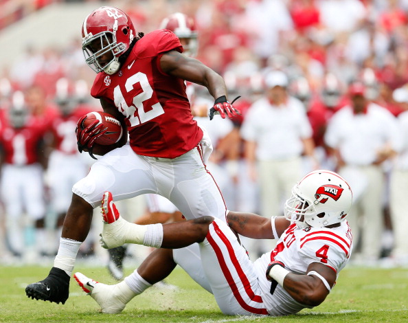 TUSCALOOSA, AL - SEPTEMBER 08:  Eddie Lacy #42 of the Alabama Crimson Tide tries to break a tackle by Andrew Jackson #4 of the Western Kentucky Hilltoppers at Bryant-Denny Stadium on September 8, 2012 in Tuscaloosa, Alabama.  (Photo by Kevin C. Cox/Getty Images)
