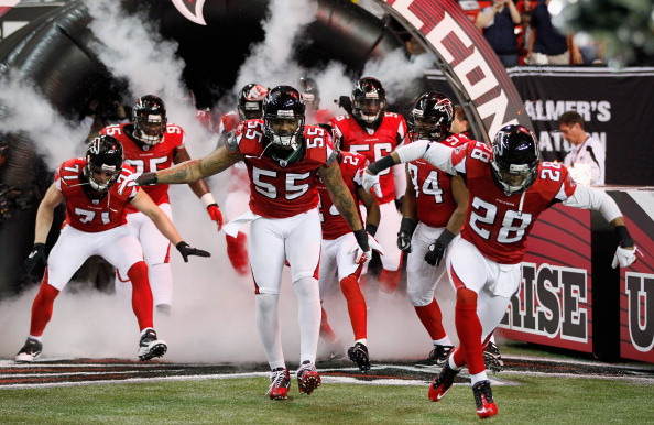 ATLANTA, GA - DECEMBER 15:  John Abraham #55 and Thomas DeCoud #28 of the Atlanta Falcons lead their teammates onto the field against the Jacksonville Jaguars at the Georgia Dome on December 15, 2011 in Atlanta, Georgia.  (Photo by Kevin C. Cox/Getty Images)