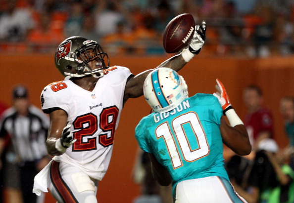 MIAMI GARDENS, FL - AUGUST 24:  Cornerback Leonard Johnson #29 of the Tampa Bay Buccaneers breaks up a pass in the end zone to receiver Brandon Gibson #10 of the Miami Dolphins at Sun Life Stadium on August 24, 2013 in Miami Gardens, Florida.  (Photo by Marc Serota/Getty Images)