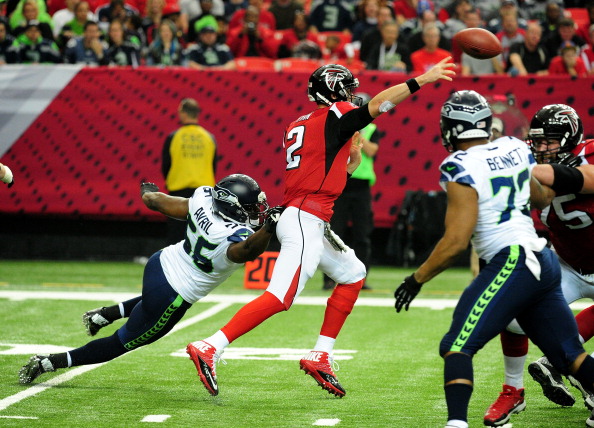 ATLANTA, GA - NOVEMBER 10: Matt Ryan #2 of the Atlanta Falcons passes as he is pressured by Cliff Avril #56 of the Seattle Seahawks at the Georgia Dome on November 10, 2013 in Atlanta, Georgia. (Photo by Scott Cunningham/Getty Images)