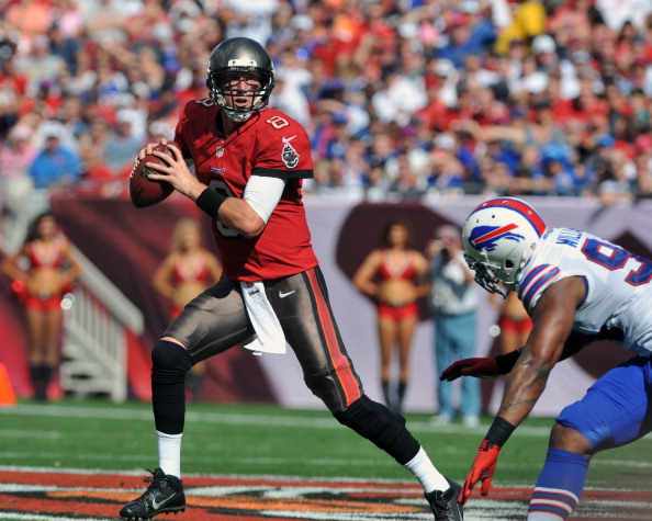 TAMPA, FL - DECEMBER 8: Quarterback Mike Glennon #8 of the Tampa Bay Buccaneers rolls out and tosses a 38-yard touchdown pass in the 1st quarter against the Buffalo Bills December 8, 2013 at Raymond James Stadium in Tampa, Florida. (Photo by Al Messerschmidt/Getty Images)