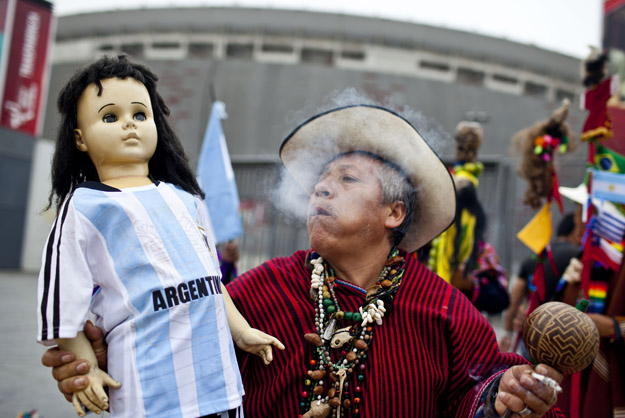 A Peruvian shaman performs a ritual of predictions for the FIFA World Cup Brazil 2014 in front of the National Stadium of Peru, in Lima June 10, 2014.