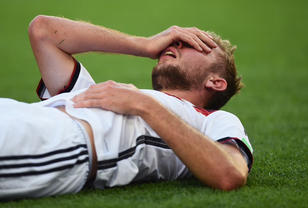 RIO DE JANEIRO, BRAZIL - JULY 13:  Christoph Kramer of Germany lies on the pitch after a collision during the 2014 FIFA World Cup Brazil Final match between Germany and Argentina at Maracana on July 13, 2014 in Rio de Janeiro, Brazil.  