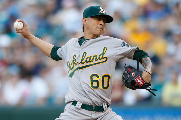 SEATTLE, WA - JULY 12:  Starting pitcher Jesse Chavez #60 of the Oakland Athletics pitches in the first inning against the Seattle Mariners at Safeco Field on July 12, 2014 in Seattle, Washington.