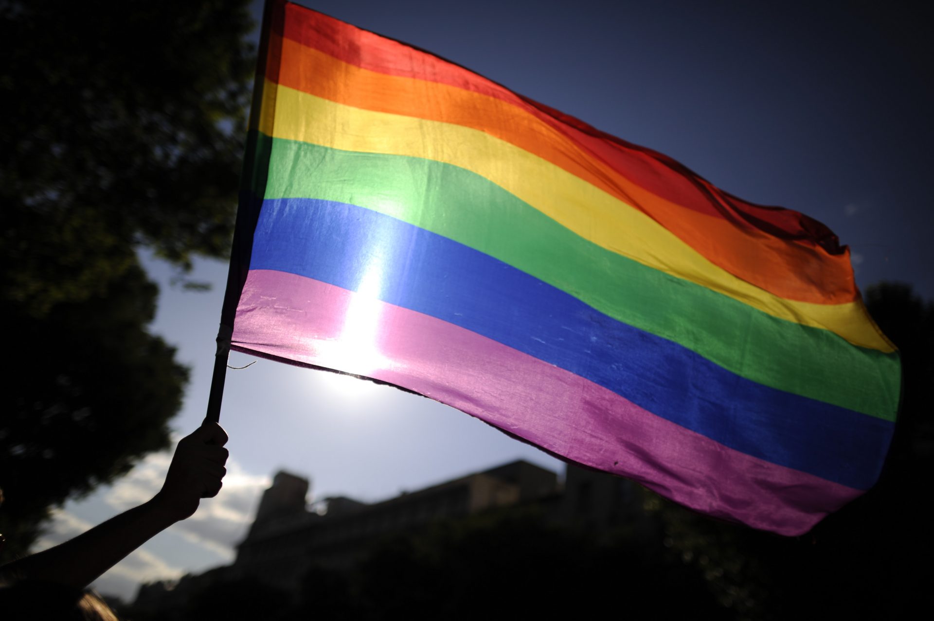 File photo of a person waving a rainbow flag. (Photo by PEDRO ARMESTRE/AFP/GettyImages)