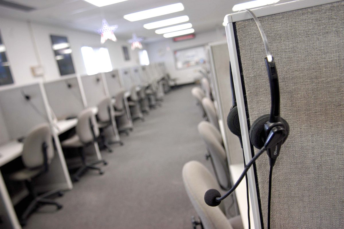 File photo of a headset near a desk in a call center. (Photo by William Thomas Cain/Getty Images)